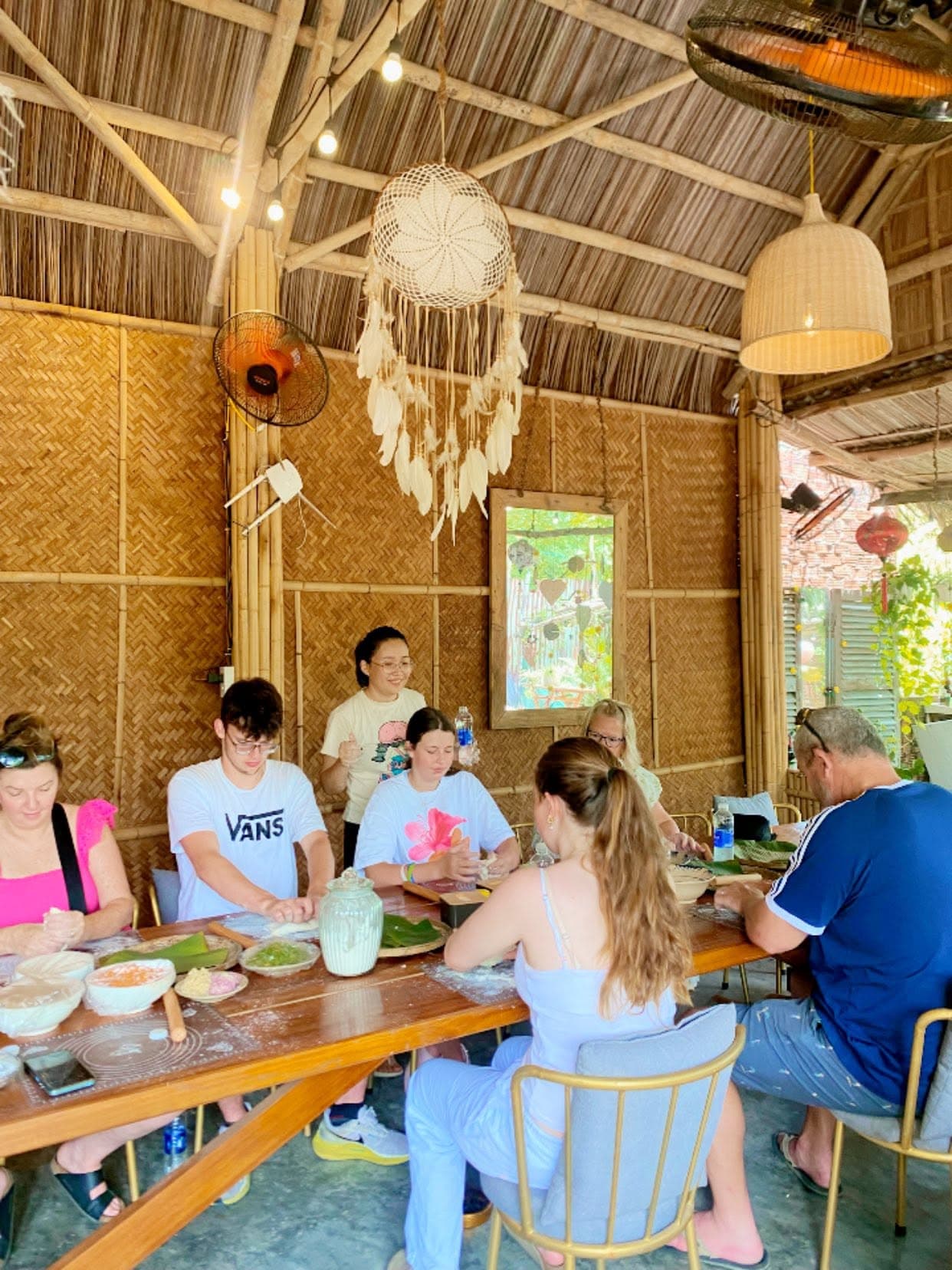 Guests folding dumplings by hand during the class